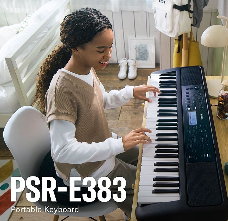 Girl happily playing the PSR-E383 on her desk.