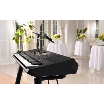 Yamaha Arranger Workstation PSR-SX720 with microphone stand at a party venue